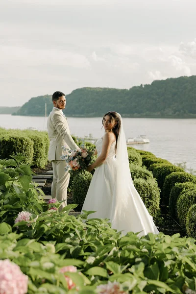 Bride and groom overlooking the ocean during an intimate destination wedding ceremony