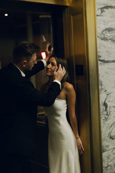 Bride and groom sharing a quiet moment in a hotel hallway after the ceremony