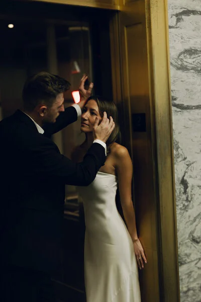 Bride and groom sharing a quiet moment in a hotel hallway after the ceremony