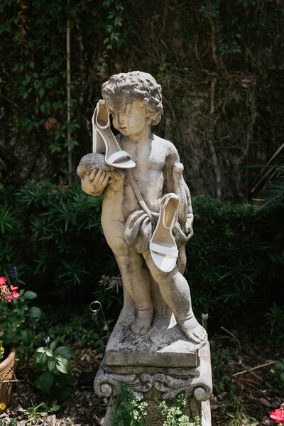 Elegant wedding detail featuring a classical garden statue