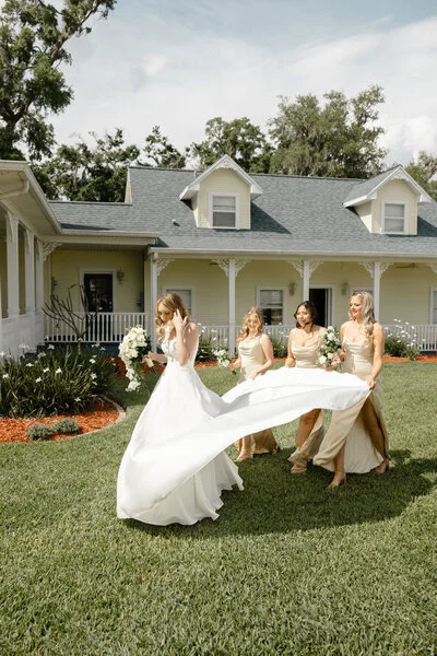 Bride celebrating outdoors with her bridesmaids before the ceremony