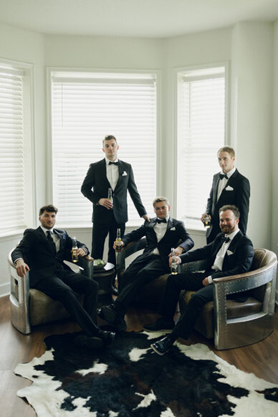 Groom and groomsmen relaxing together before the wedding ceremony
