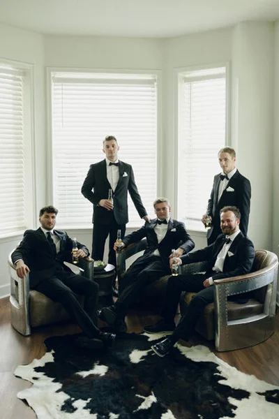 Groom and groomsmen relaxing together before the wedding ceremony