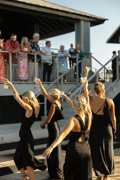 Bridesmaids dancing together during the outdoor wedding reception
