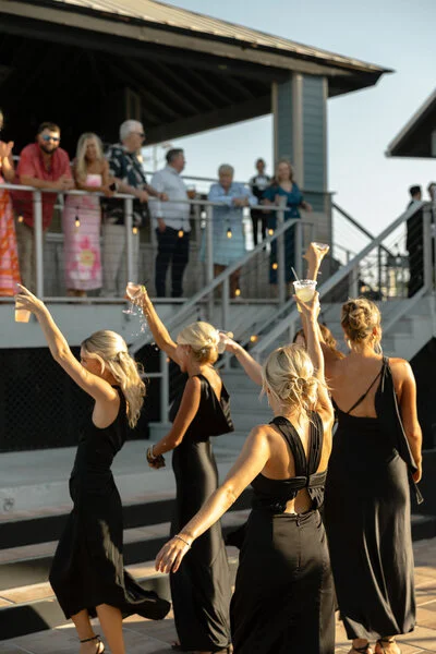 Bridesmaids dancing together during the outdoor wedding reception