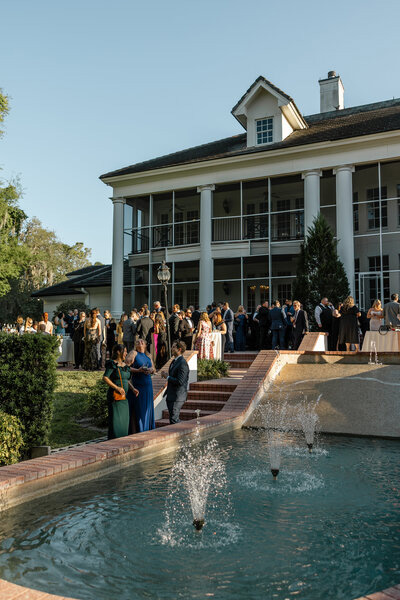 Guests arriving at an elegant wedding venue with fountain entrance