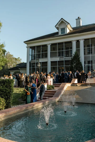 Guests arriving at an elegant wedding venue with fountain entrance