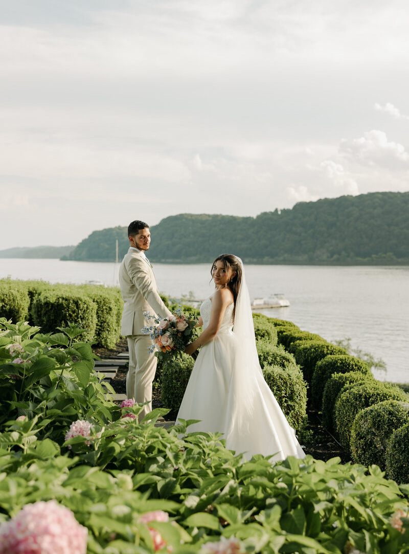 Bride and groom photographed at a waterfront wedding