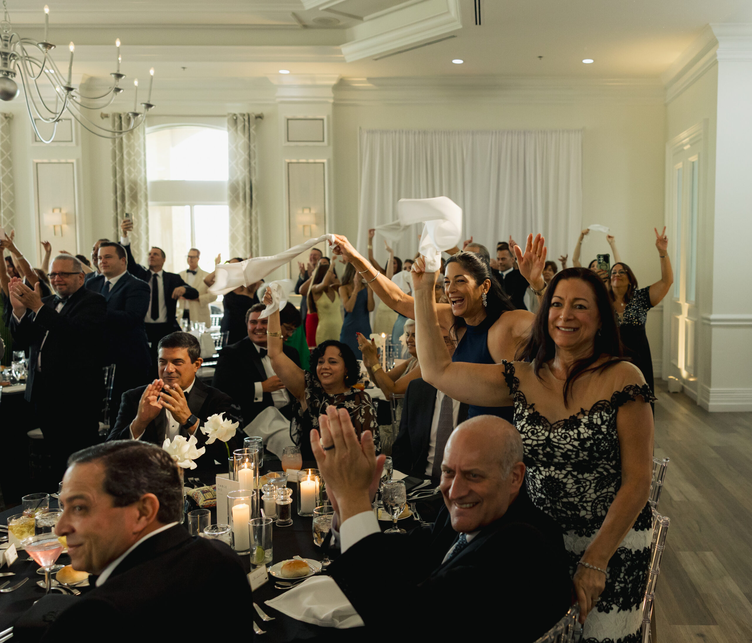 Candid guest reactions during reception entrance at luxury Naples wedding